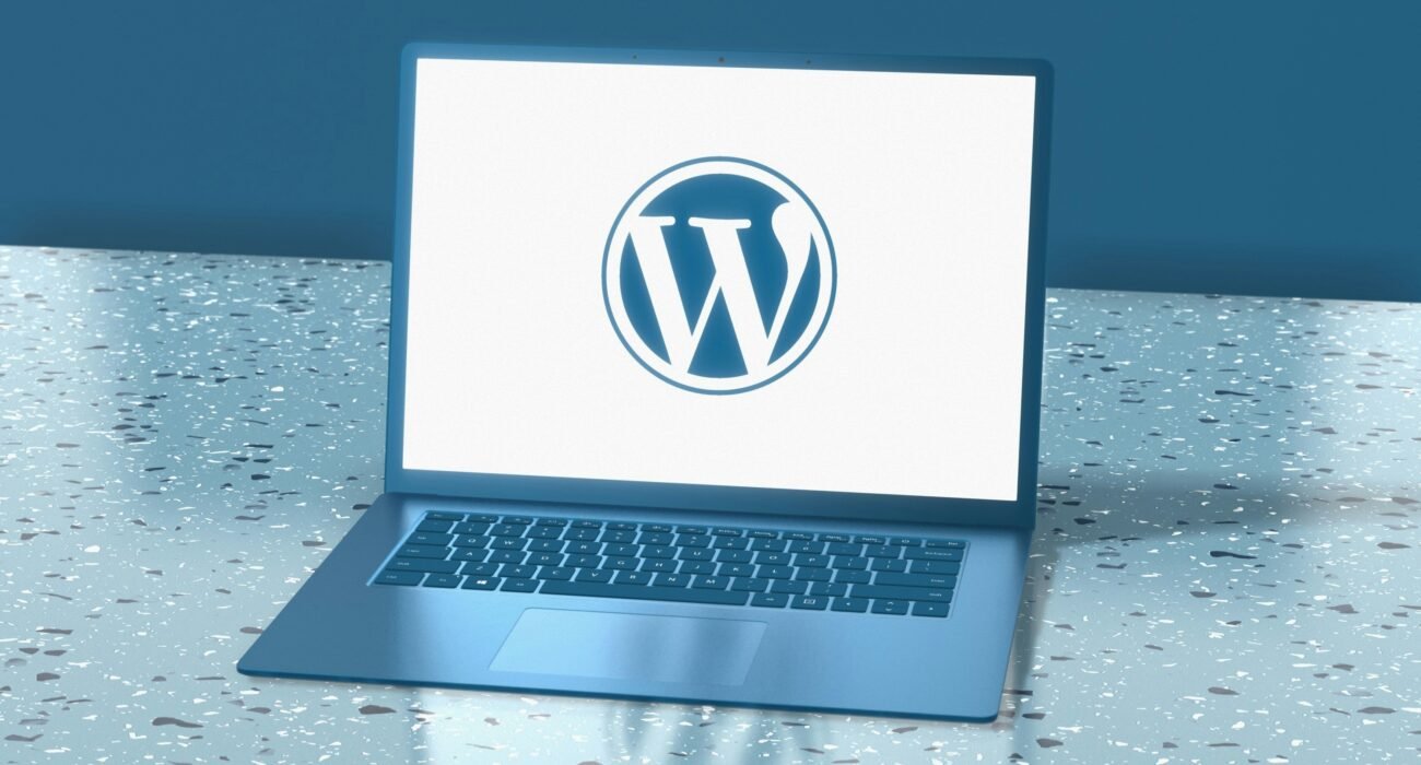 WordPress logo displayed on a laptop screen, representing website design and development services.