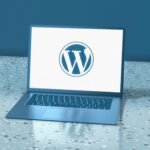 WordPress logo displayed on a laptop screen, representing website design and development services.