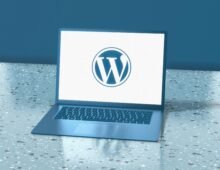 WordPress logo displayed on a laptop screen, representing website design and development services.